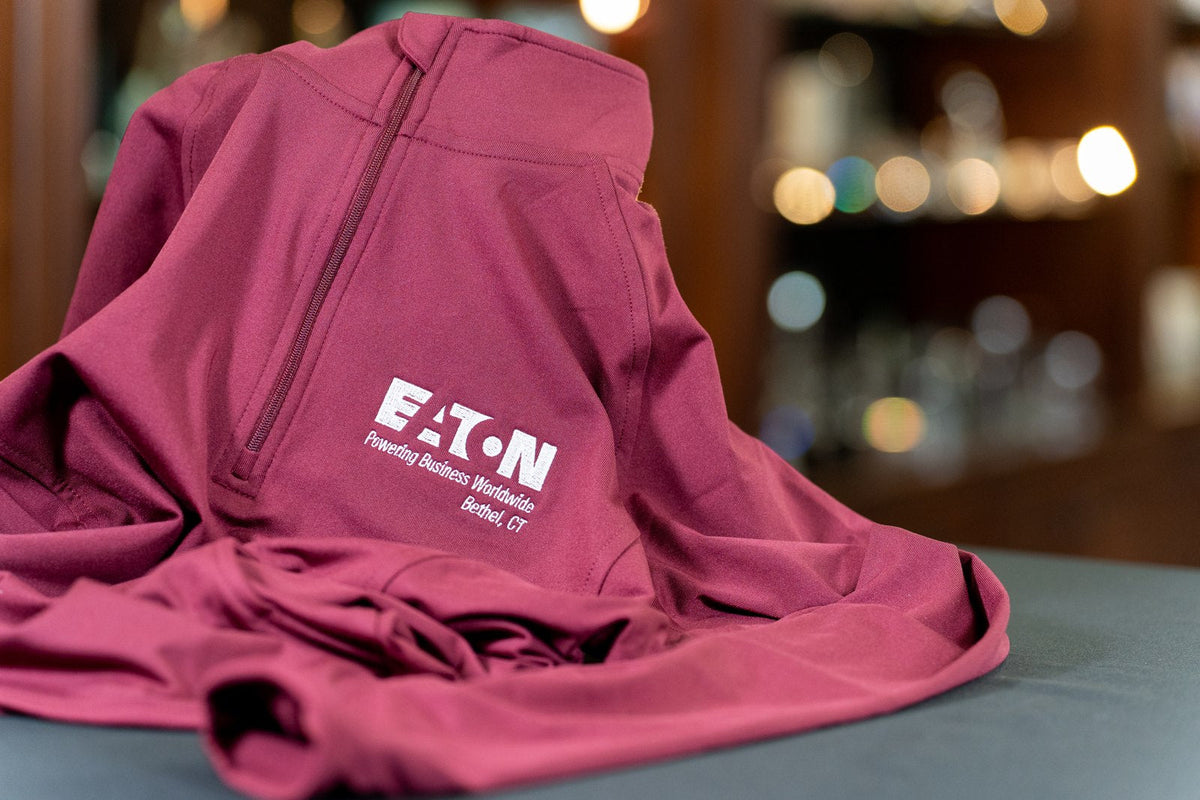 White embroidered Eaton logo on a burgundy quarter-zip.