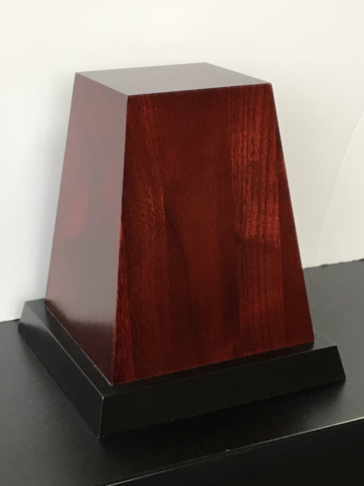 Tapered wood base for the John R. Wooden Award before plates are mounted