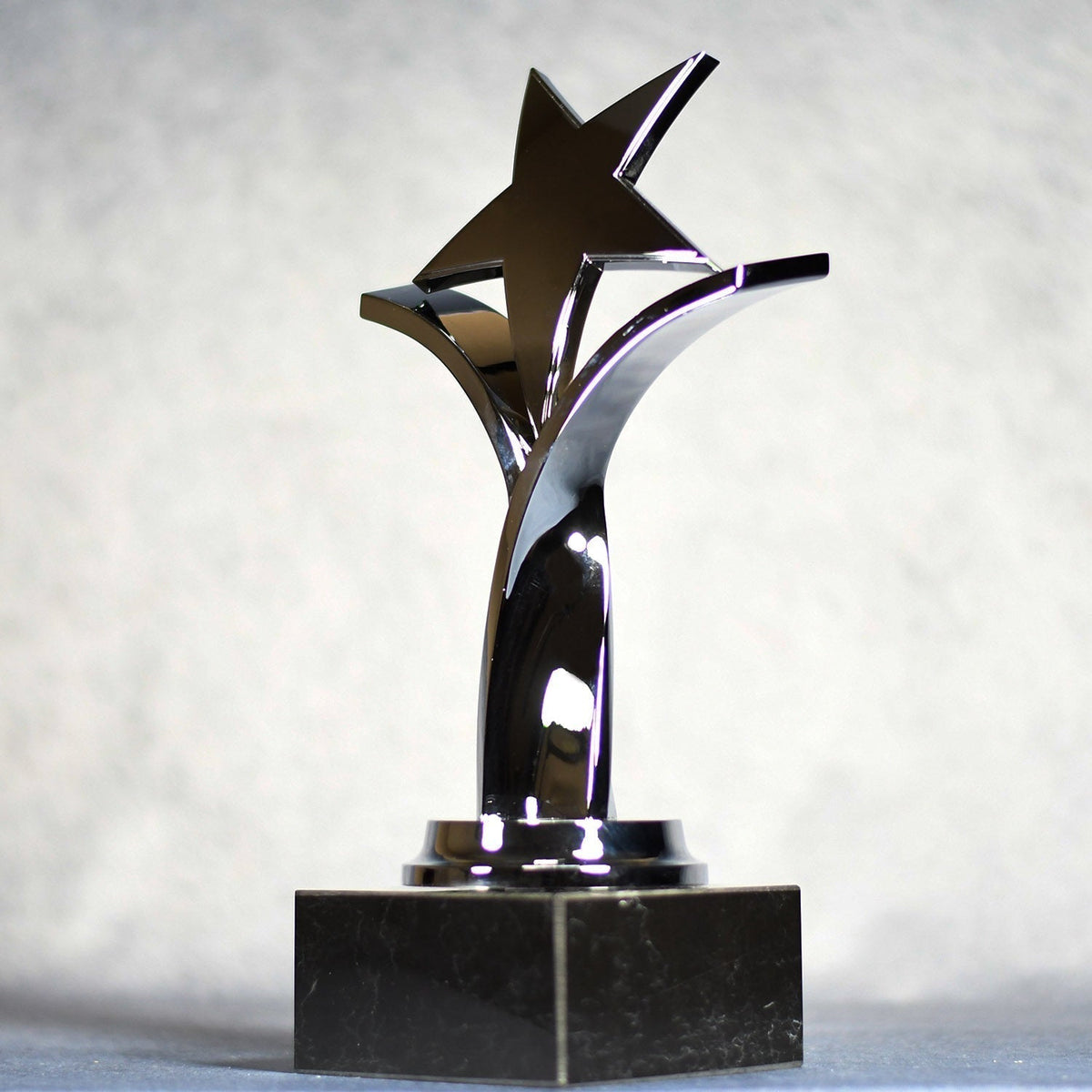 Twisting Star On Black Marble Base, left side view