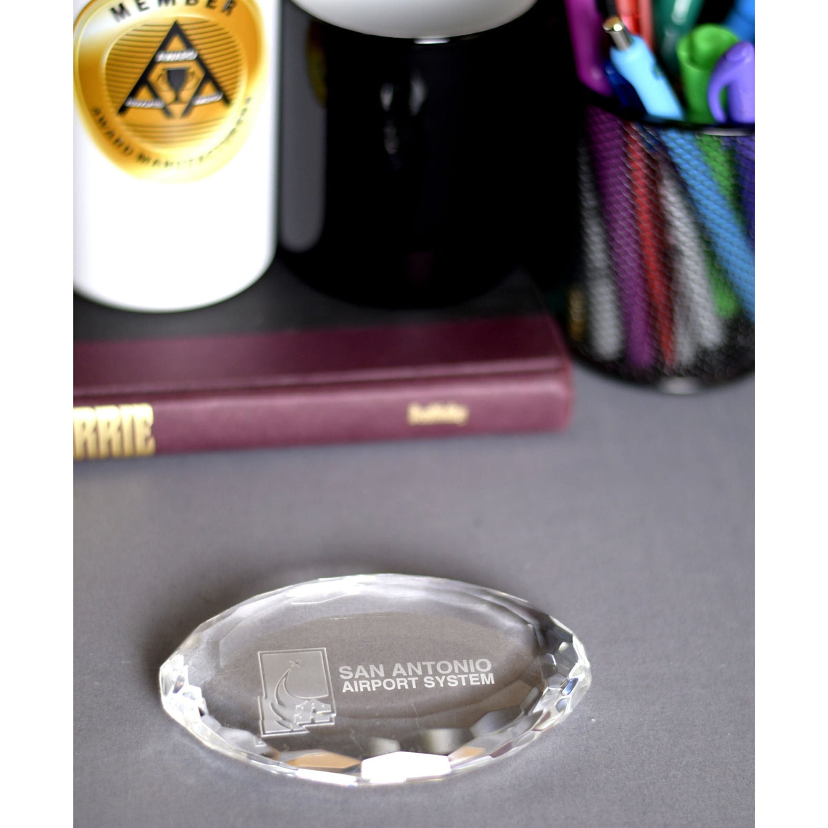 Crystal Oval Multi-Faceted Paperweight, shown in use